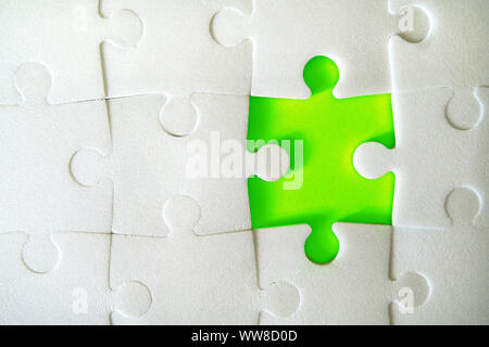Multiple white puzzle pieces put together without one piece. View from above. Close up image. Stock Photo