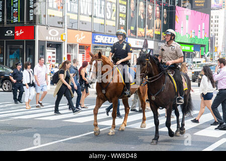 Two Police Officers can be seen on horses in Time Square, New York City.  Photo Credit:  Marty Jean-Louis Stock Photo