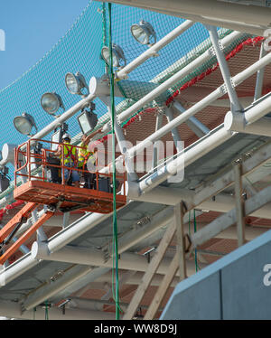 Bergamo Italy 12 September 2019: Workers working on elevating platform while restoring the lighting lamps of the Bergamo stadium Stock Photo