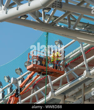 Bergamo Italy 12 September 2019: Workers working on elevating platform while restoring the lighting lamps of the Bergamo stadium Stock Photo