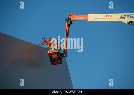 Bergamo Italy 12 September 2019: Workers working on elevating platform while restoring the lighting lamps of the Bergamo stadium Stock Photo