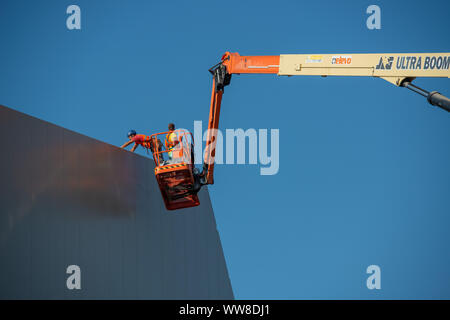 Bergamo Italy 12 September 2019: Workers working on elevating platform while restoring the lighting lamps of the Bergamo stadium Stock Photo