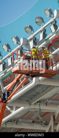 Bergamo Italy 12 September 2019: Workers working on elevating platform while restoring the lighting lamps of the Bergamo stadium Stock Photo