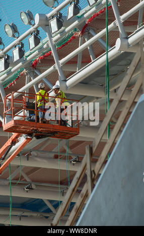 Bergamo Italy 12 September 2019: Workers working on elevating platform while restoring the lighting lamps of the Bergamo stadium Stock Photo