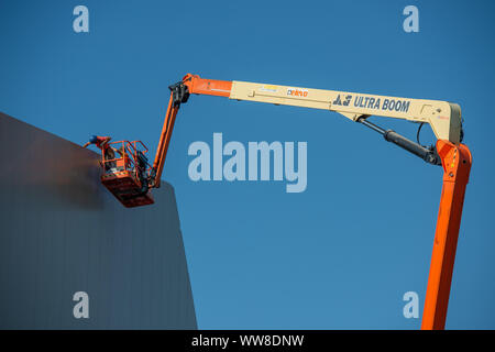 Bergamo Italy 12 September 2019: Workers working on elevating platform while restoring the lighting lamps of the Bergamo stadium Stock Photo