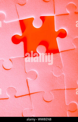 Multiple white puzzle pieces put together without one piece. View from above. Stock Photo