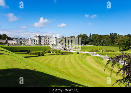 Tourists visiting Powerscourt Gardens one of the most beautiful gardens in Ireland view on mansion from terraced lawn Stock Photo
