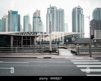 Futuristic building of Dubai metro station and modern skyscrapers in Dubai, United Arab Emirates Stock Photo