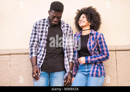 ethnic afroamerican black young couple enjoy the afternoon in leisure outdoor activity together. friendship and relationship concept for 20 years old people laugh and have fun in casual clothes Stock Photo