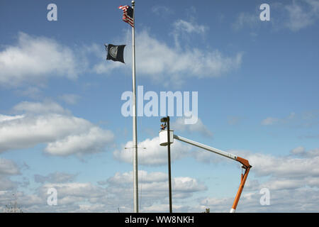 Electrician working on a street light using a bucket truck. U.S.A. Stock Photo