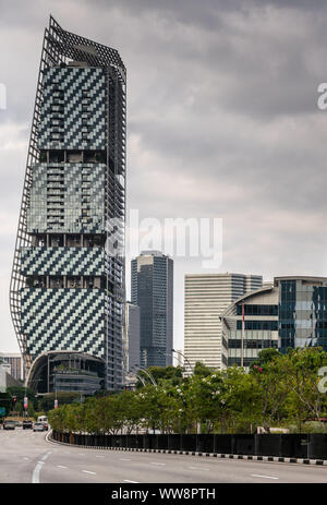 Singapore - March 20, 2019: Iconic JW Marriott hotel towers on Nicoll highway under heavy cloudscape. Traffic on the road. Some green foliage. Stock Photo