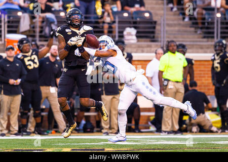 Winston-Salem, NC, USA. 13th Sep, 2019. Wake Forest Demon Deacons wide receiver Scotty Washington (7) has his pass broken up by North Carolina Tar Heels defensive back Greg Ross (10) in the second quarter of the NCAA matchup at BB&T Field in Winston-Salem, NC. (Scott Kinser/Cal Sport Media) Credit: csm/Alamy Live News Stock Photo