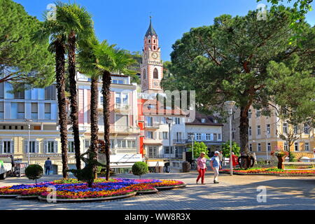 Flower arrangements on the spa promenade and tower of the parish church, Merano, Etschtal, Burggrafenamt, South Tyrol, Italy Stock Photo