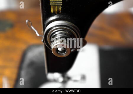 close up of the correct set up for the tensioning system for an antique (1918) sewing machine Stock Photo