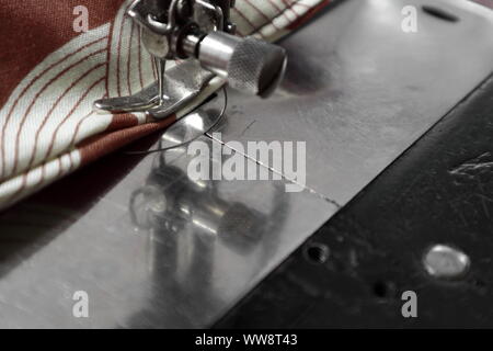 close up of sewing machine foot and feed on a vintage singer 127 Stock Photo
