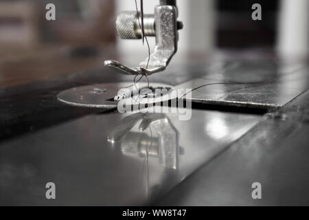 close up of sewing machine foot and feed on a vintage singer 127 Stock Photo