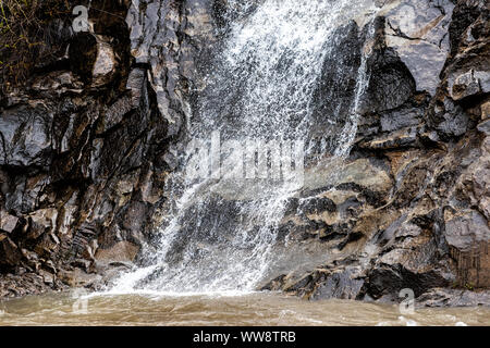 Small waterfall abstract closeup flowing into river in Redstone, Colorado during summer Stock Photo