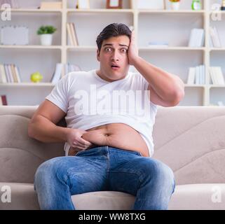 The man suffering from extra weight in diet concept Stock Photo