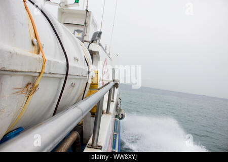 BATAM, INDONESIA - 12 DECEMBER 2018: POV for the ferry sailing from the side and water moving. Stock Photo