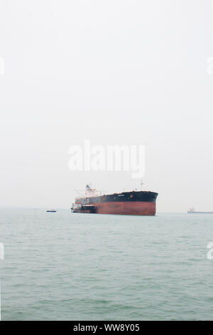 BATAM, INDONESIA - 12 DECEMBER 2018: Ferry and ships transporting passengers during morning from JB ferry center to batam center, beautiful forest bac Stock Photo