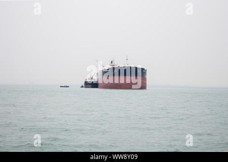 BATAM, INDONESIA - 12 DECEMBER 2018: Ferry and ships transporting passengers during morning from JB ferry center to batam center, beautiful forest bac Stock Photo