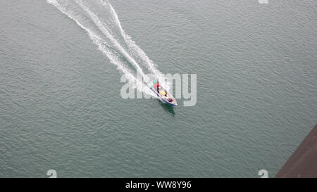 BATAM, INDONESIA - 12 DECEMBER 2018: Ferry and ships transporting passengers during morning from JB ferry center to batam center, beautiful forest bac Stock Photo