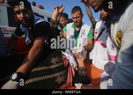 Gaza. 13th Sep, 2019. Palestinian medics carry a woman wounded in clashes with Israeli troops on the border with Israel, in east of southern Gaza Strip city of Khan Younis, Sept. 13, 2019. Credit: Khaled Omar/Xinhua/Alamy Live News Stock Photo