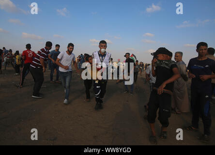 Gaza. 13th Sep, 2019. Palestinian medics carry a boy wounded in clashes with Israeli troops on the border with Israel, in east of southern Gaza Strip city of Khan Younis, Sept. 13, 2019. Credit: Khaled Omar/Xinhua/Alamy Live News Stock Photo