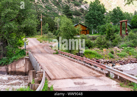 Redstone, USA - July 1, 2019: Highway 133 in Colorado during summer with red bridge on Crystal river and ranch property Stock Photo