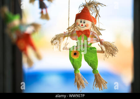 Decoration made out of straw with bright colored clothings with bokeh background Stock Photo