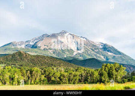 Mt Sopris mountain in Carbondale, Colorado town view with snow mountain peak and sky in summer during sunset Stock Photo