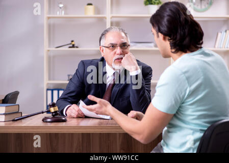 The young man visiting experienced male lawyer Stock Photo