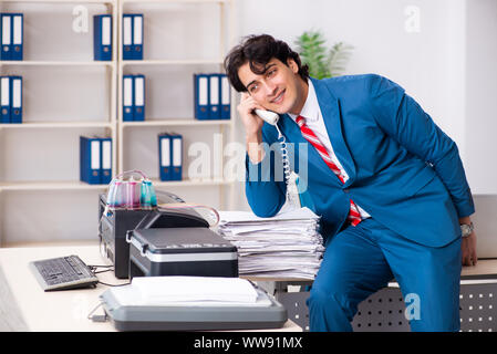 The young employee making copies at copying machine Stock Photo