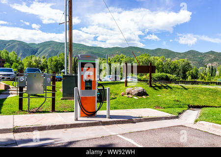 Basalt, USA - July 14, 2019: Electric vehicle charging station at parking lot space near farmers market with nobody during summer Stock Photo