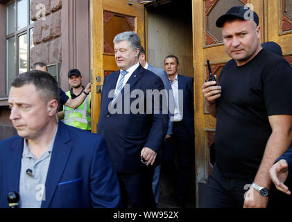 Kiev, Ukraine. 13th Sep, 2019. Former Ukrainian President Petro Poroshenko (C) leaving, after his questioning at the State Investigations Bureau building in Kiev, Ukraine. The fifth President of Ukraine, Petro Poroshenko testified in the case of the nationalization of a Private Bank and capture of Ukrainian sailors in the Kerch Strait, as local media agency (UNIAN) reported. Law enforcers are searching the premises of 'International Investment Bank', whose main owner is former Ukrainian President Petro Poroshenko. Credit: SOPA Images Limited/Alamy Live News Stock Photo