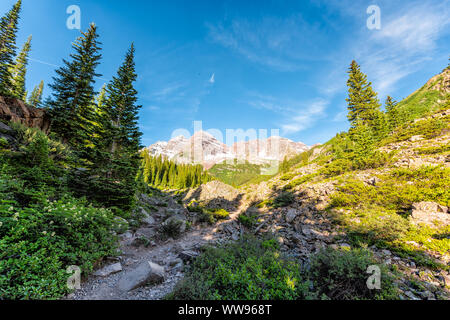 Maroon Bells peak view in Aspen, Colorado in July 2019 summer on trail path road wide angle view