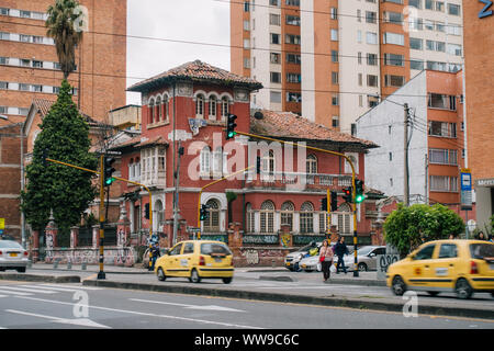 a Spanish colonial style house stands out on the corner of a busy traffic intersection in Chapinero, Bogota, Colombia Stock Photo