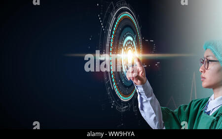 woman doctor holding hand on hud technology screen and pressing start button on dark screen, medical technology concept Stock Photo