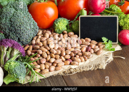 Pinto beans and vegatables on the old wooden table Stock Photo