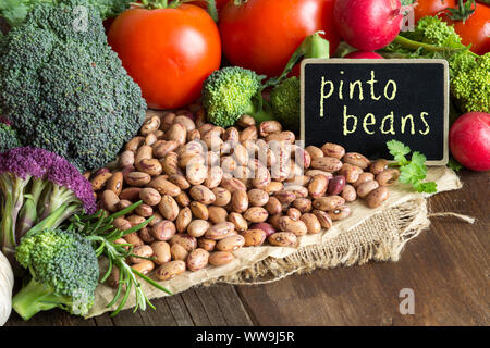 Pinto beans and vegatables on the old wooden table Stock Photo