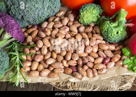 Pinto beans and vegatables on the old wooden table Stock Photo