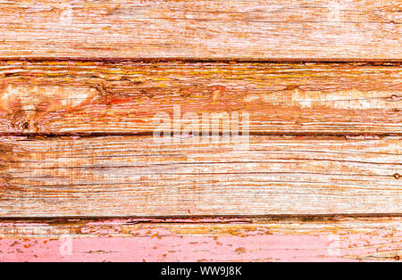 Old rough wooden boards with cracks as background. Wooden planks texture with the shabby red paint Stock Photo