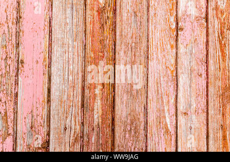 Old rough wooden boards with cracks as background. Wooden planks texture with the shabby red paint Stock Photo