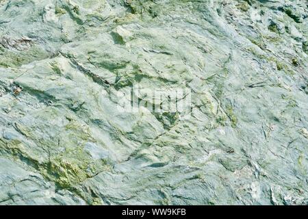 Green-turquoise rough stone background Stock Photo