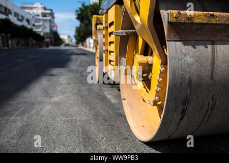 Close view on the road roller working on the new road construction site. Stock Photo