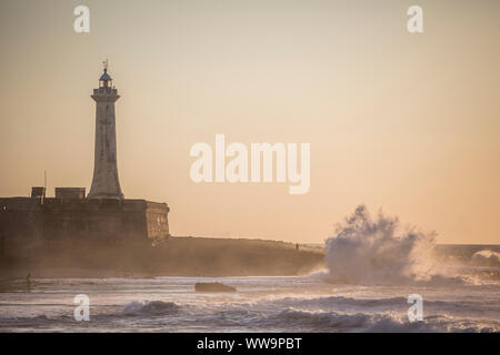 Lighthouse in Rabat, Morocco during the sunset with big waves crashing. Stock Photo