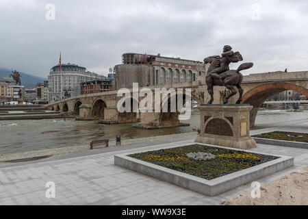 SKOPJE, NORTH MACEDONIA - FEBRUARY 24, 2018: Skopje City Center, Old Stone Bridge, Monument of Karposh and Vardar River, North Macedonia Stock Photo