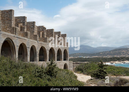 Naxos, Greece - June 28, 2018: The ruins of a building sit seaside in Alykó, on the southwestern shore of the island of Naxos. Stock Photo