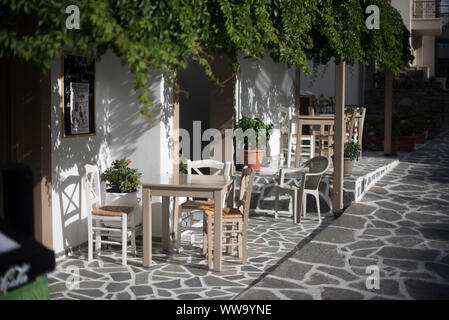 Naxos, Greece - June 28, 2018: Tables outside a restaurant on the island of Naxos, a spot popular with tourists to Greece. Stock Photo