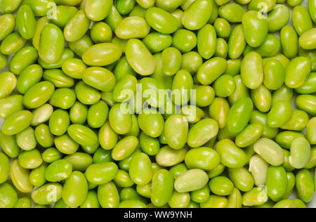 Edamame. Green soybeans. Also called mukimame, unripe soya beans outside the pod. Glycine max, a legume, edible after cooking and a protein source. Stock Photo